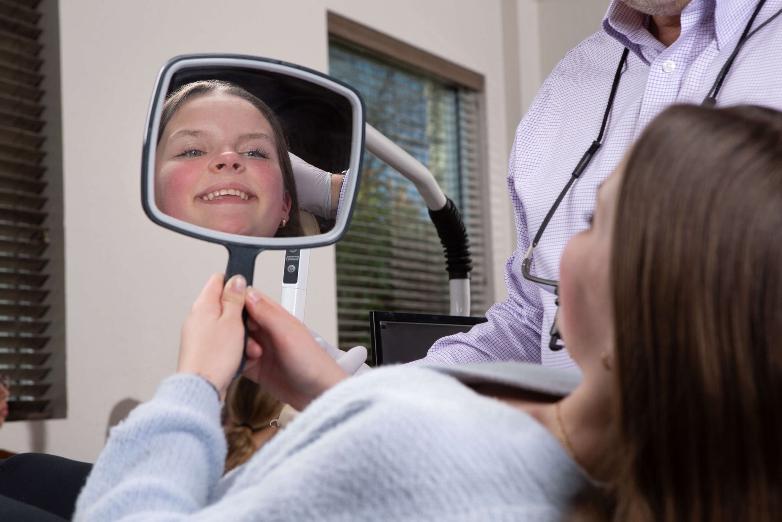 Child with braces smiling during an orthodontic appointment, representing early orthodontic treatment at Brazos Valley Orthodontics in Bryan College Station, TX.